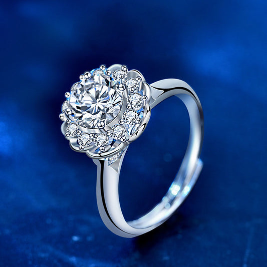Bloom halo moissanite engagement ring in sterling silver, angled view with round center and CZ accents.