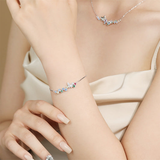 Sterling silver butterfly bolo bracelet with multicolor CZ stones on wrist; matching necklace shown.
