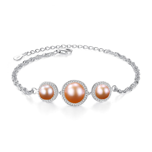 Pink cultured-pearl bracelet with CZ halo on white background.