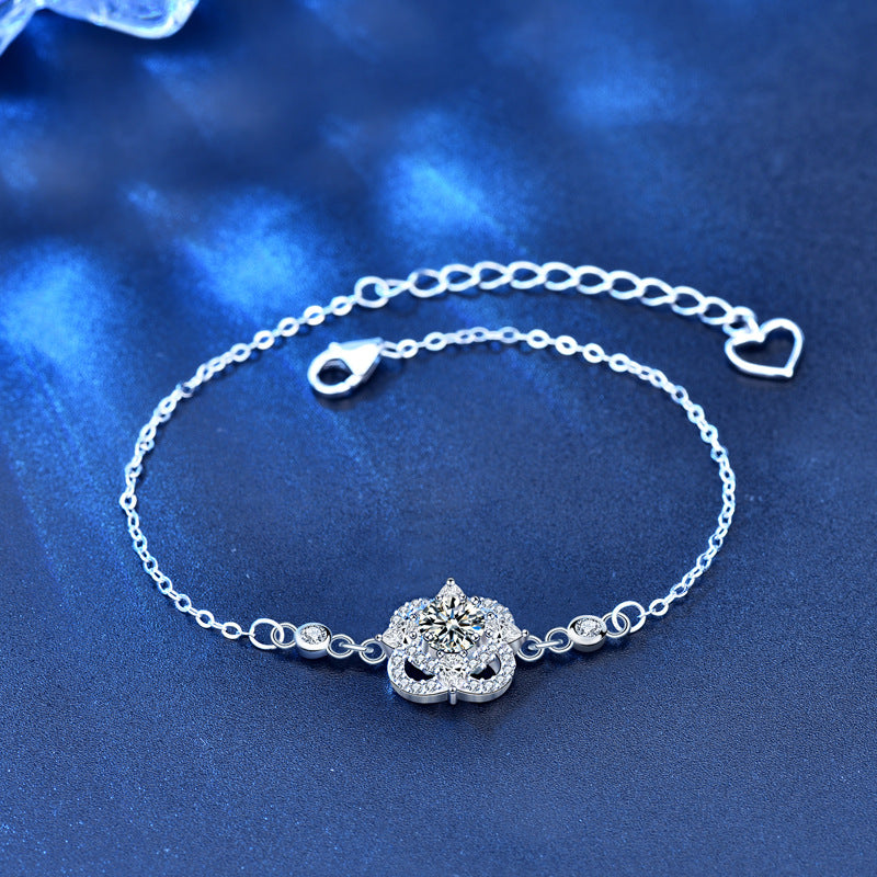 Adjustable sterling-silver four-leaf clover bracelet showing CZ details and heart chain extender