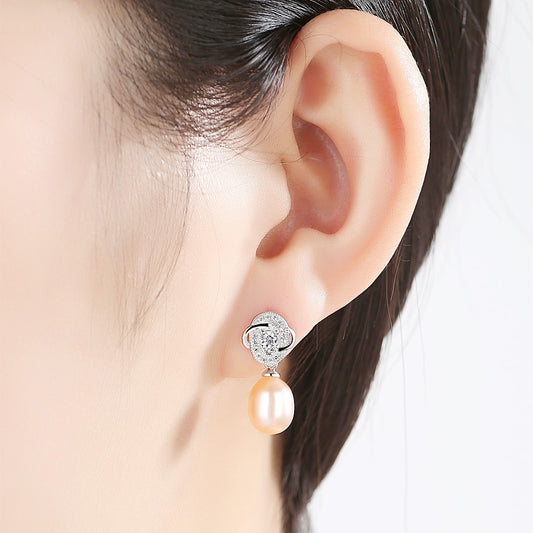 Model wearing pink freshwater pearl CZ dangle earring in rhodium-plated sterling silver.