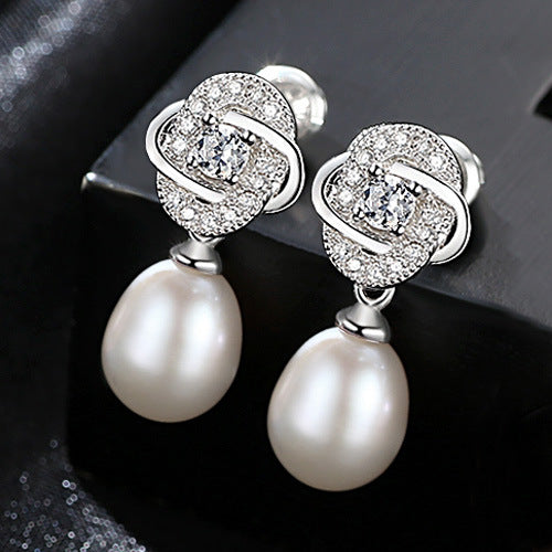 White freshwater pearl CZ dangle earrings in rhodium-plated 925 sterling silver.