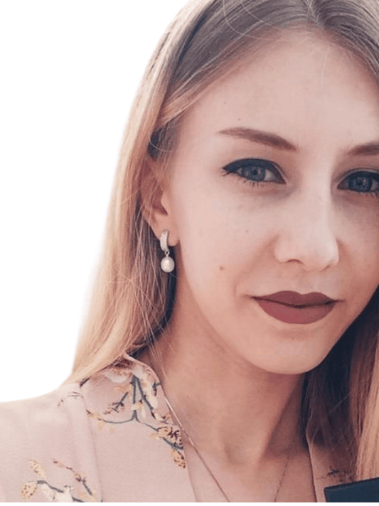 Model wearing freshwater pearl dangle earrings with pavé-CZ hoops for a delicate everyday look.