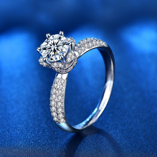 Side view of 1 ct moissanite ring with raised crown setting and CZ accents over rhodium-plated silver band.