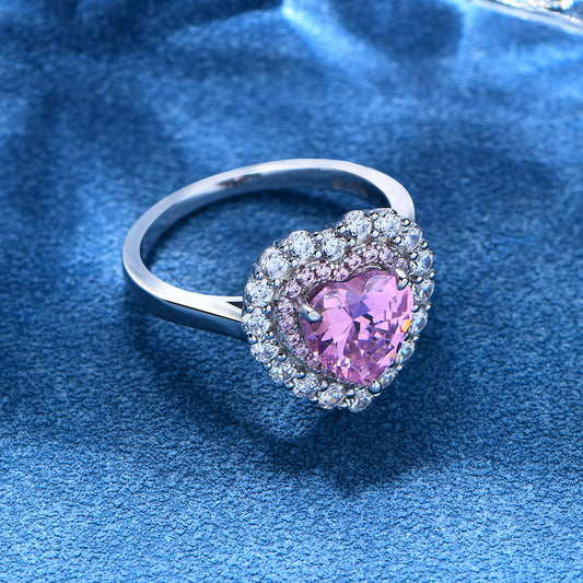 Pink heart-shaped CZ halo ring with pink inner halo and white CZ outer halo on sterling silver band.