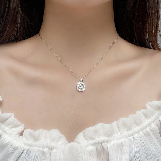 Woman wearing the moissanite perfume bottle necklace, showcasing delicate elegance at the neckline