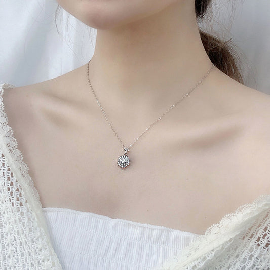 Model wearing delicate moissanite sunshine pendant necklace at the collarbone