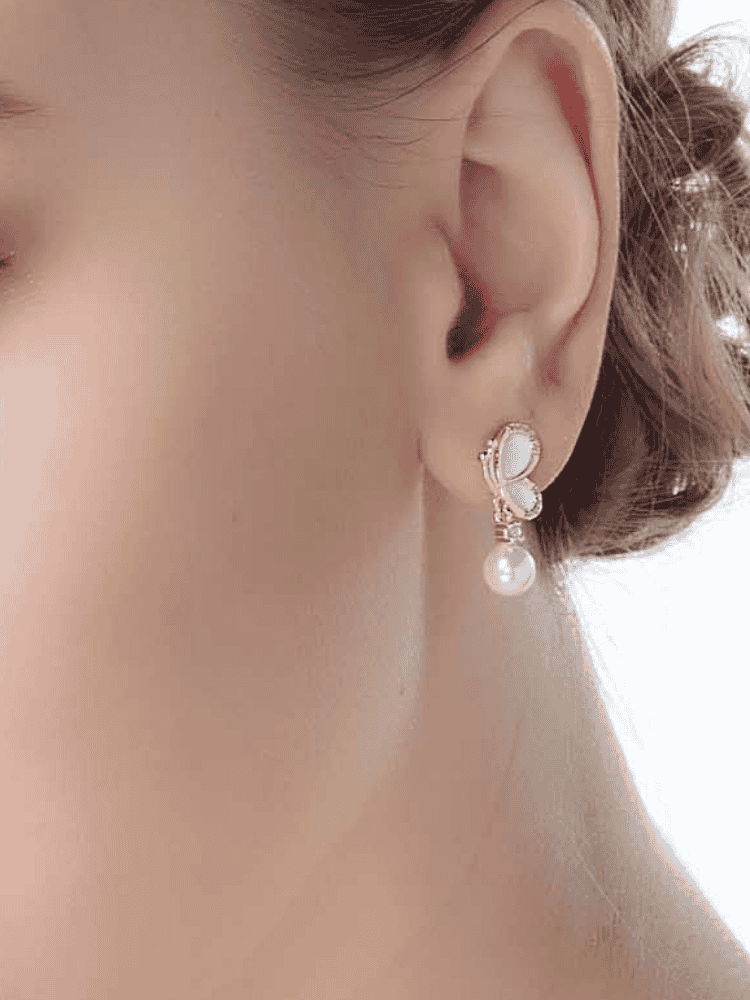 Side profile with white enamel butterfly pearl dangle earring in 18K gold-plated 925 silver with CZ accents.