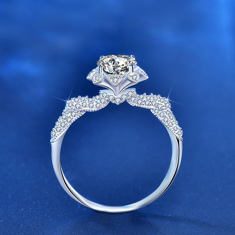 Side view of 1 ct moissanite floral halo ring in rhodium-plated 925 silver with CZ pavé shoulders and heart gallery.