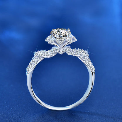Side view of 1 ct moissanite floral halo ring in rhodium-plated 925 silver with CZ pavé shoulders and heart gallery.