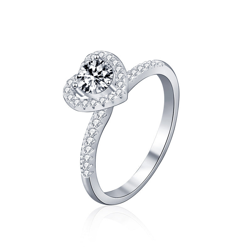 Studio product image of heart halo moissanite engagement ring in rhodium-plated sterling silver.