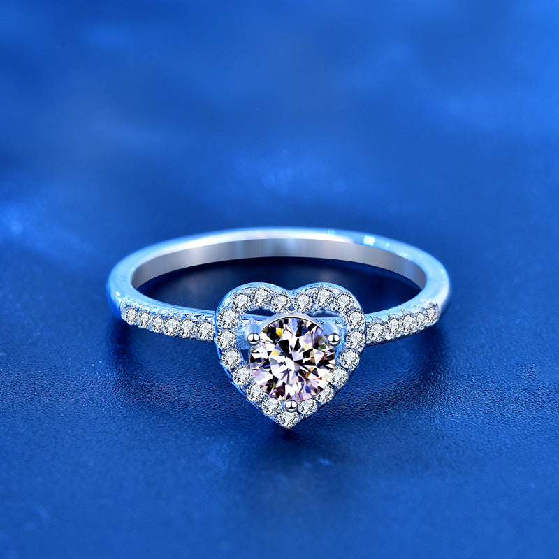 Front view of 1ct round moissanite set in heart halo with pavé CZ shank, sterling silver ring.