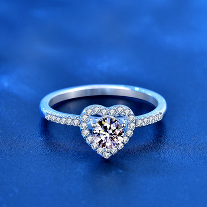Front view of 1ct round moissanite set in heart halo with pavé CZ shank, sterling silver ring.