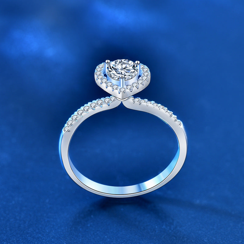 Side profile showing heart halo gallery and pavé CZ shoulders on sterling silver moissanite ring.