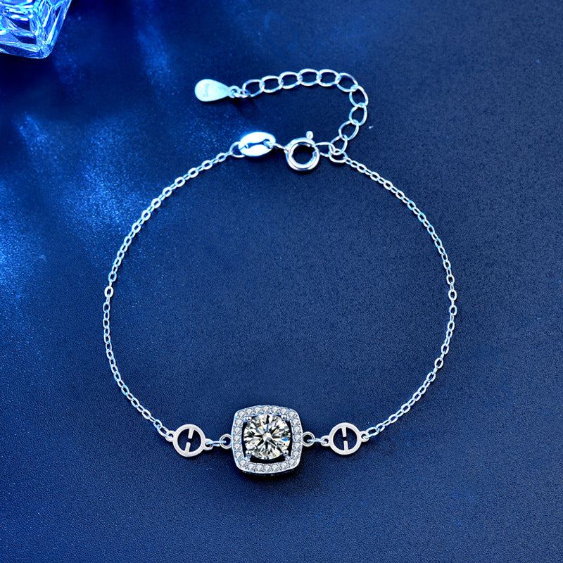 Top view of sterling-silver cushion halo moissanite bracelet with fine chain and extender.