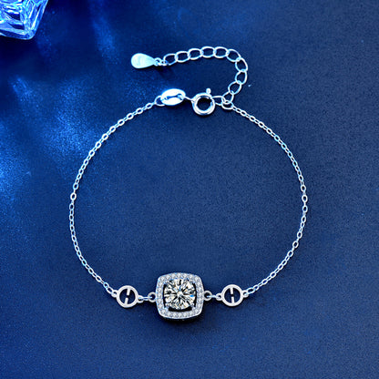 Top view of sterling-silver cushion halo moissanite bracelet with fine chain and extender.