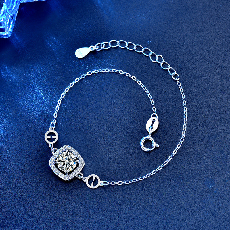 Angled view of cushion halo moissanite bracelet showing extender chain and spring-ring clasp.