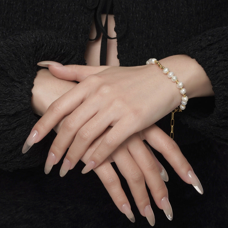 Gold finish baroque pearl bracelet on wrist with paper-clip extender