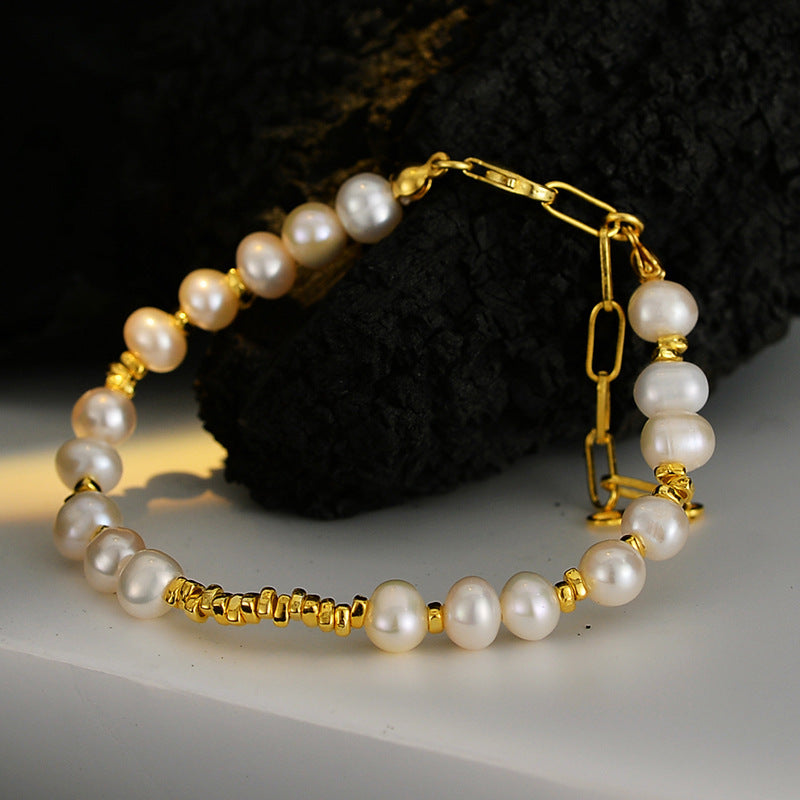 Close-up of baroque pearl bracelet with gold finish and paper-clip chain