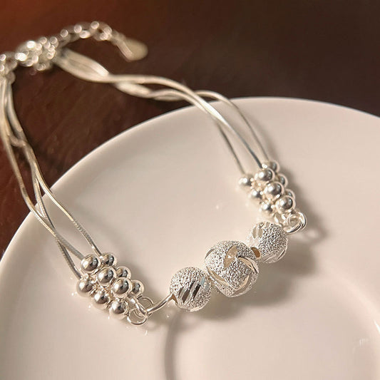 Close-up of stardust beads on triple-strand 925 sterling-silver bracelet