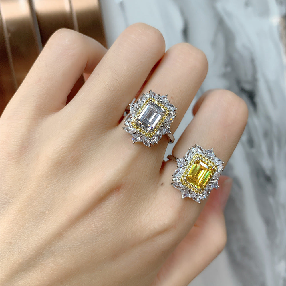 Close view of fingers styled with yellow and white baguette-cut CZ halo flower rings.