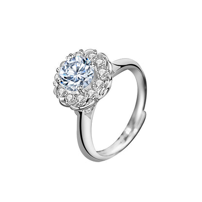 Studio product shot of sterling silver bloom halo moissanite engagement ring on white background.