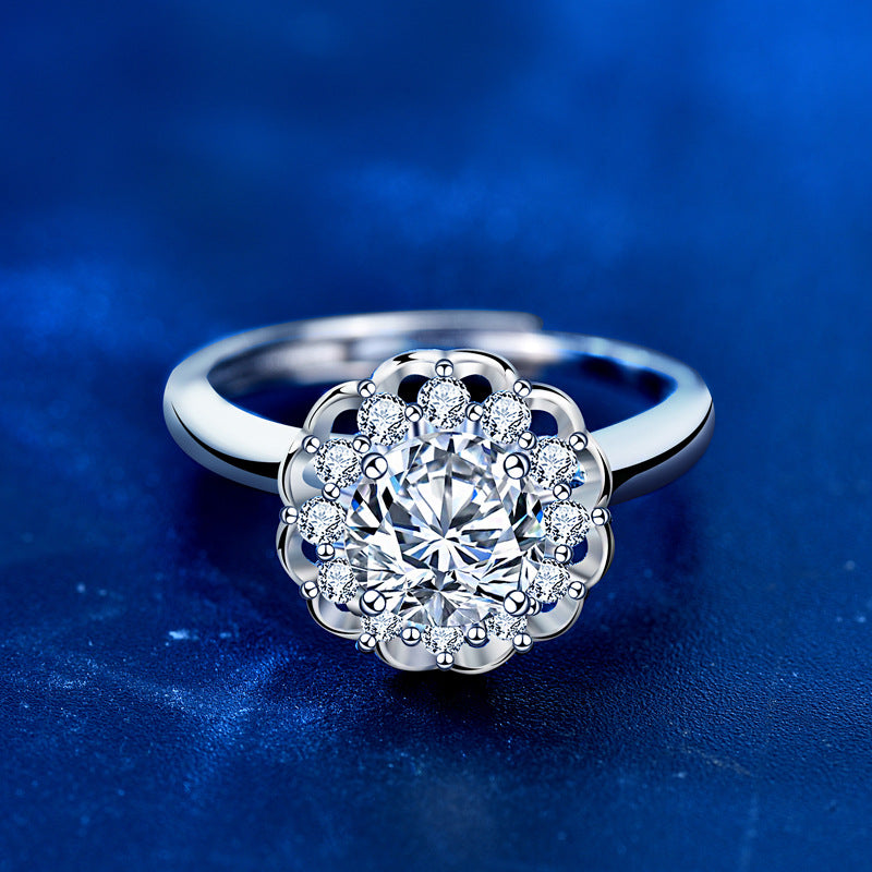 Top view of bloom halo moissanite ring with round center stone and pavé CZ petals in polished sterling silver.
