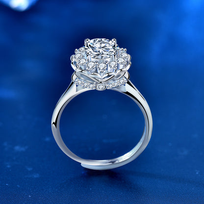 Side profile of sterling silver moissanite ring showing layered bloom halo and pavé accents on the shoulders.