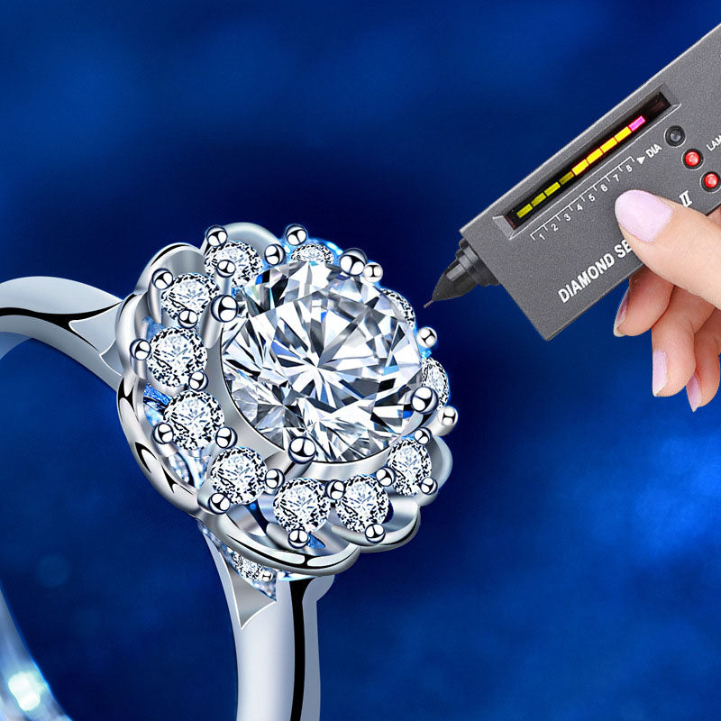 Moissanite bloom halo ring shown with a diamond tester to demonstrate brilliance and heat response.