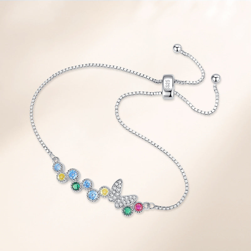 Close-up of 925-stamped sliding bolo clasp and butterfly charm bracelet with multicolor CZ stones in sterling silver.