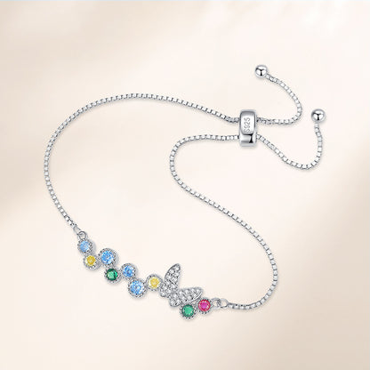 Close-up of 925-stamped sliding bolo clasp and butterfly charm bracelet with multicolor CZ stones in sterling silver.