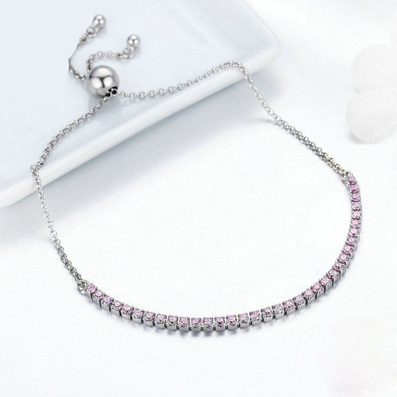 Close-up of silver adjustable bracelet with pink CZ stones