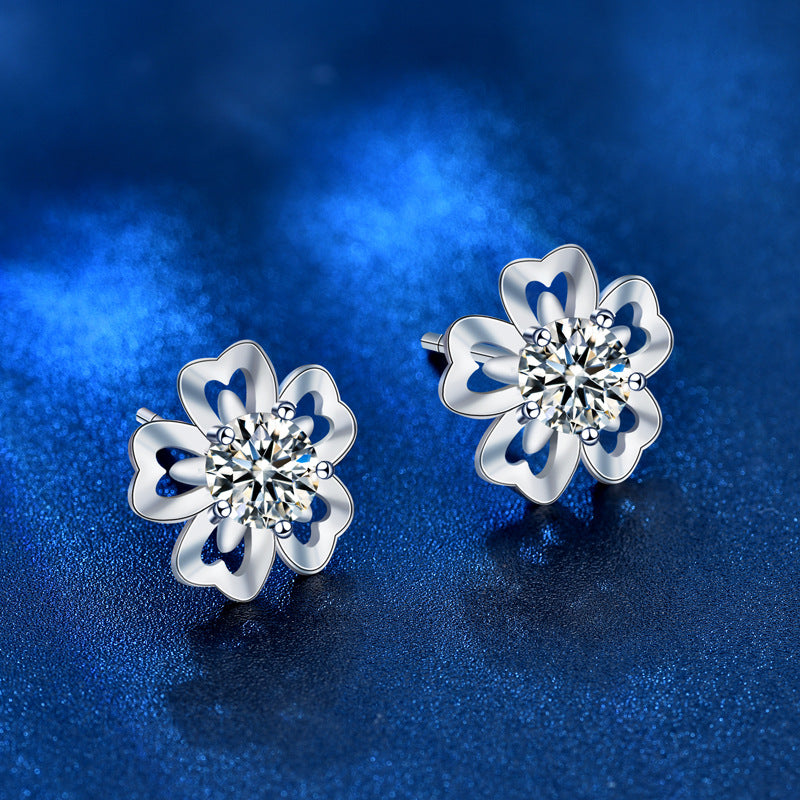 Angled view of cherry-blossom moissanite stud earrings