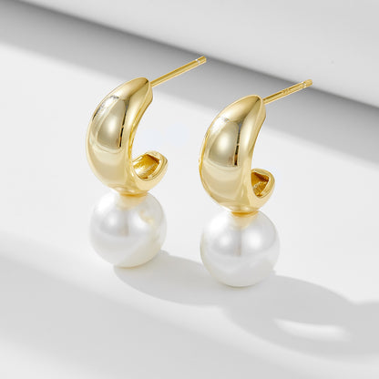 Pair of gold-finish C-hoop created pearl dangle earrings, front view.
