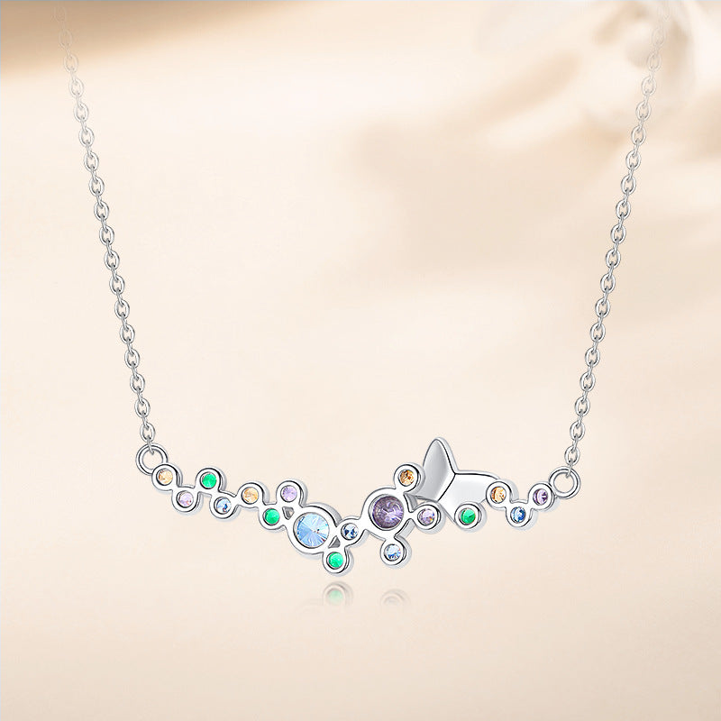 Reverse view of sterling silver butterfly necklace with smooth finish and colorful stones