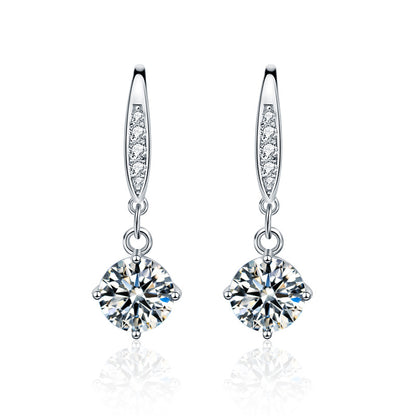 Studio image of sterling silver moissanite dangle earrings with CZ-pavé accents on ear wires