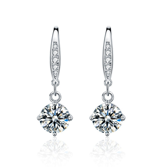 Studio image of sterling silver moissanite dangle earrings with CZ-pavé accents on ear wires
