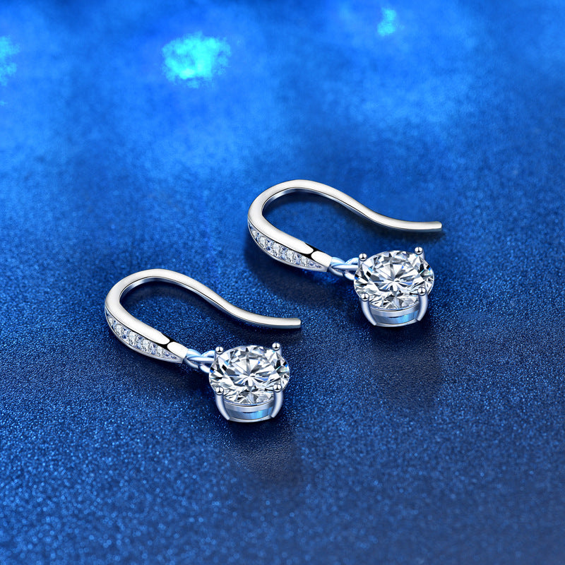 Angled side view showing CZ-pavé ear wires and round moissanite dangles in sterling silver