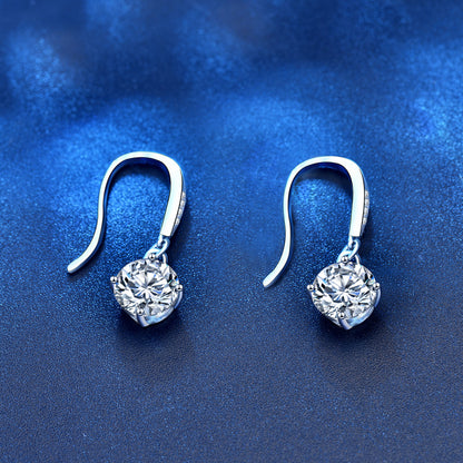 Overhead view of French-hook moissanite dangle earrings in rhodium-plated sterling silver
