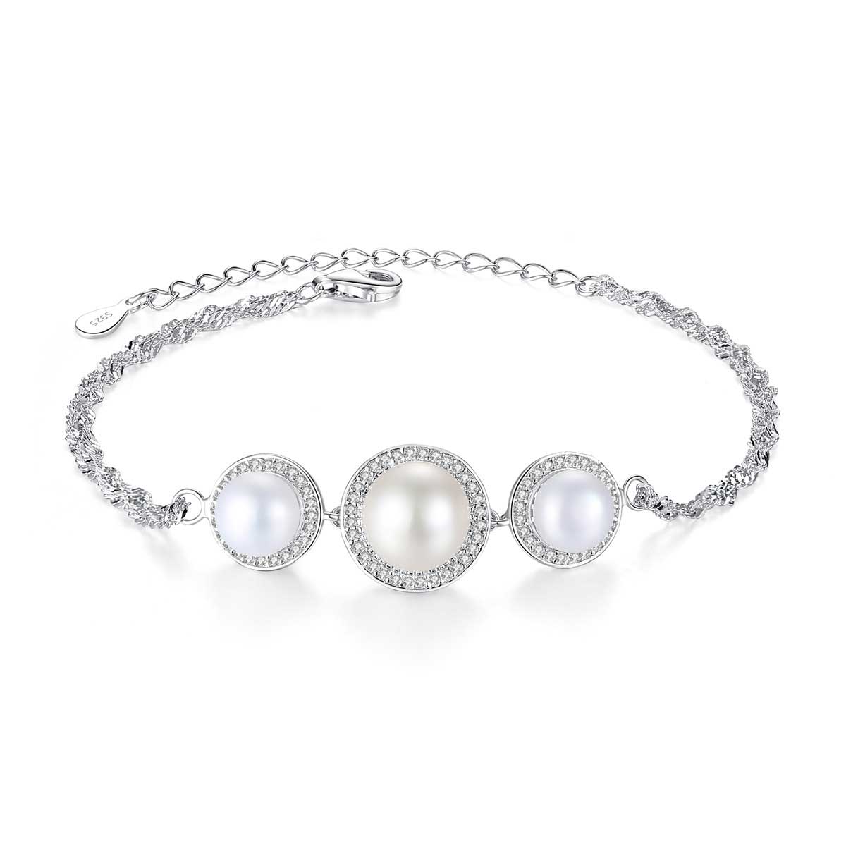 Sterling-silver bracelet with three white cultured pearls and CZ halos on white background