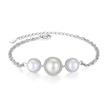 Sterling-silver bracelet with three white cultured pearls and CZ halos on white background