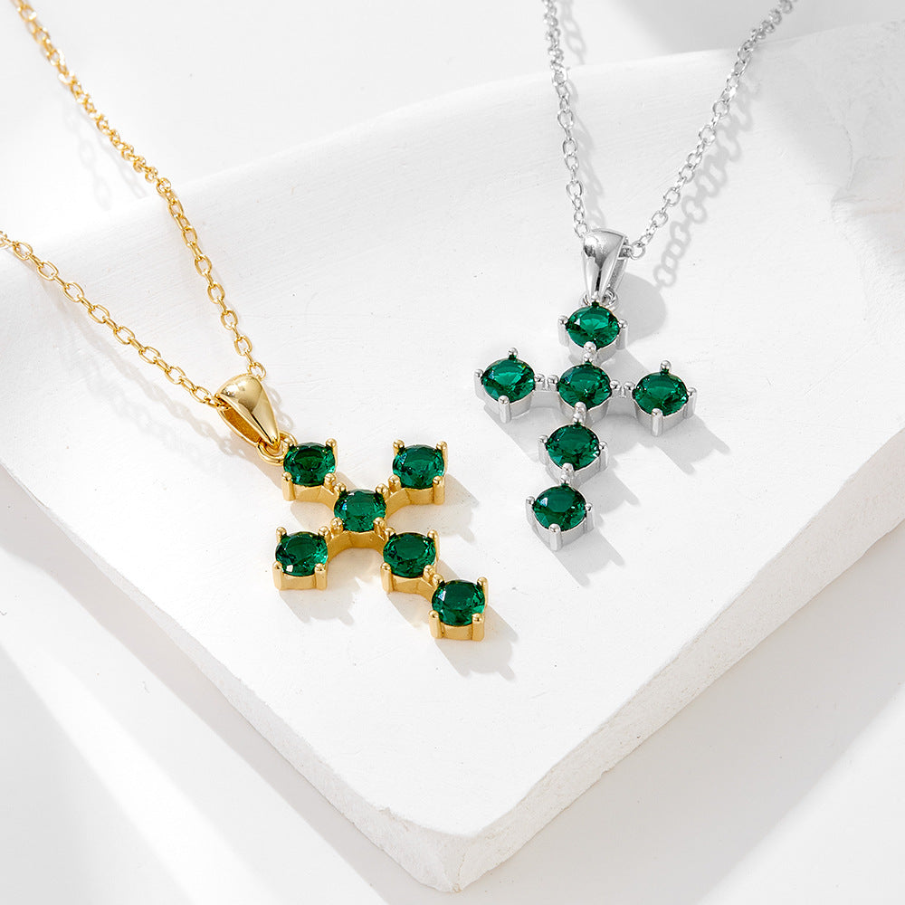 Gold and silver green CZ cross pendant necklaces displayed together
