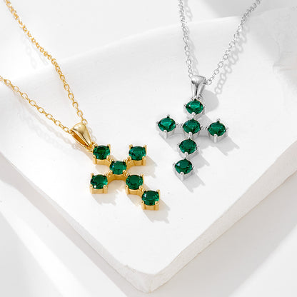 Gold and silver green CZ cross pendant necklaces displayed together
