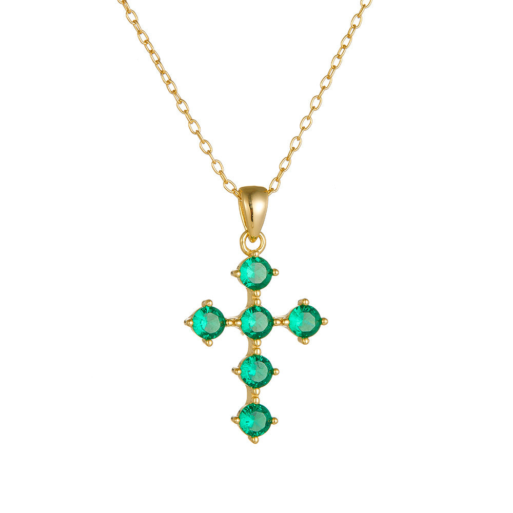 Front view of gold green CZ cross pendant necklace on chain