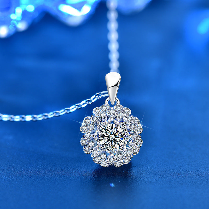 Shimmering Moissanite flower necklace elegantly displayed on reflective blue surface