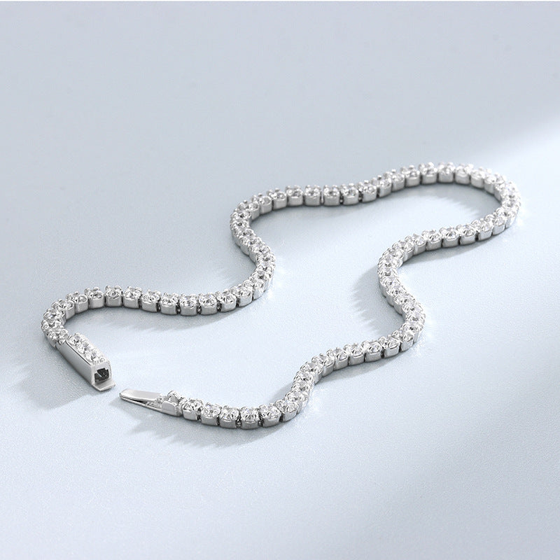 Sterling-silver round CZ tennis bracelet with open clasp, curved on soft surface