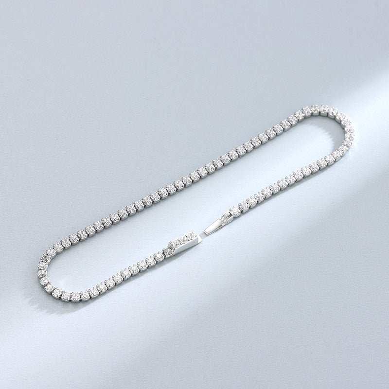Slim sterling-silver round CZ tennis bracelet laid flat