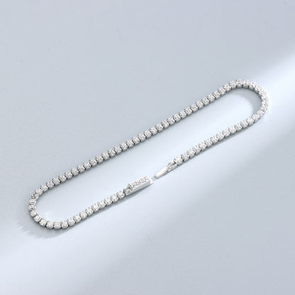 Slim sterling-silver round CZ tennis bracelet laid flat