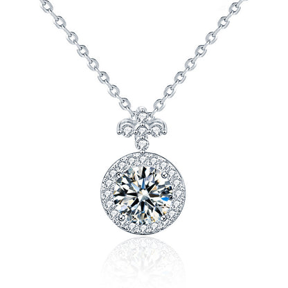 Studio product shot of moissanite halo pendant necklace with fleur-de-lis bail on a white background.