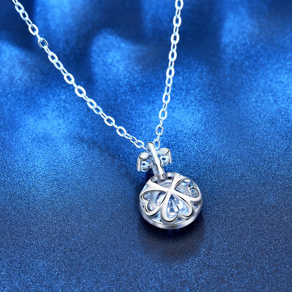 Back view showing openwork four-leaf-clover setting behind the round moissanite pendant.